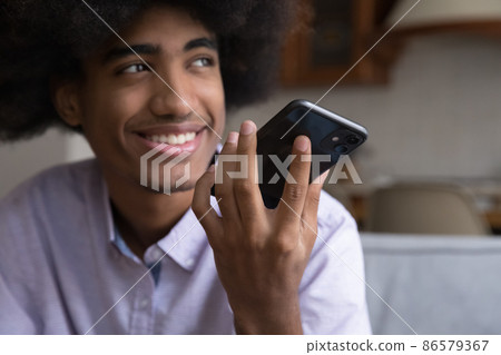 Happy teenage young guy talking on cell on speaker 86579367