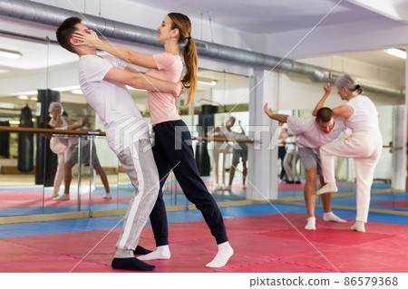 Woman performing eye-gouging move during self-defence training 86579368