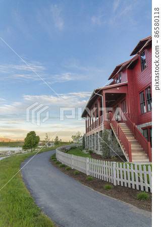 Curved asphalt pathway at the front of a fenced house at Daybreak, Utah 86580118
