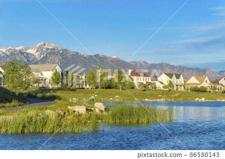 Oquirrh Lake with curved asphalt walkway on the side at Daybreak, Utah 86580143