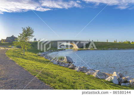 Oquirrh Lake at Daybreak, Utah with rocky shoreline 86580144