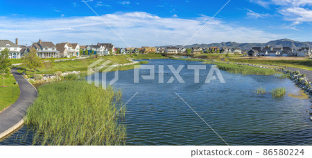 Oquirrh Lake at Daybreak in Utah with paved sidewalk on the side 86580224
