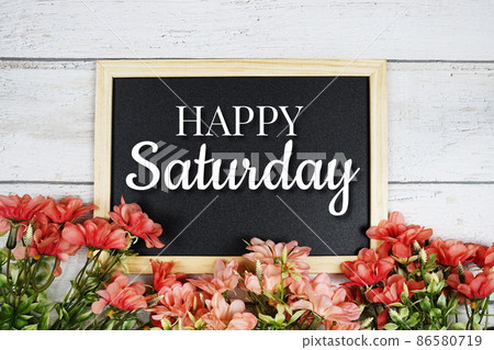 Happy Saturday text on blackboard with flower bouquet decoration 86580719