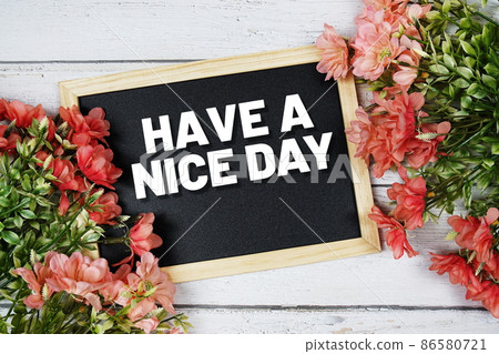 Have a nice day text on blackboard with flower bouquet decoration 86580721