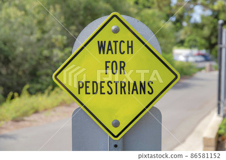 Reflective yellow pedestrian signs at the side of the road in Newport Beach, California 86581152