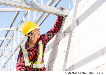 Construction worker or contractor checking house frame Construction worker or contractor checking house frame 86581331