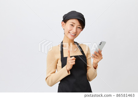 Female staff in an apron clerk 86581463
