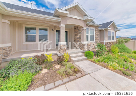 Front exterior of a house with messy front yard garden 86581636