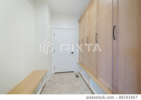 Mudroom interior of a house with white walls and door Mudroom interior of a house with white walls and door 86581667