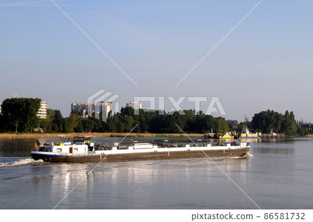 Cargo ship crossing the Scheldt river in Antwerp Cargo ship crossing the Scheldt river in Antwerp 86581732