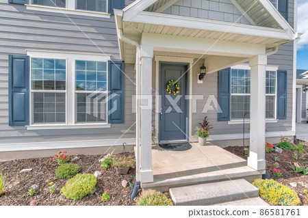Home exterior with gray wood vinyl siding and white frames Home exterior with gray wood vinyl siding and white frames 86581761