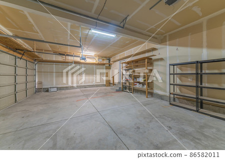 Large garage interior with wall filler white markings and shelves 86582011