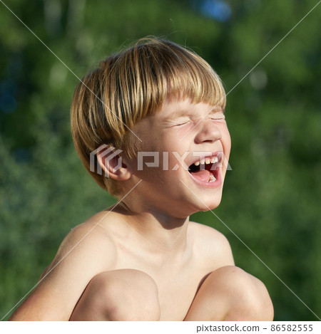 portrait of little angry boy shouting and screaming in outdoor 86582555
