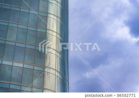 Curved building exterior with glass curtain wall against the cloudy sky at Salt Lake City in Utah Curved building exterior with glass curtain wall against the cloudy sky at Salt Lake City in Utah 86582771