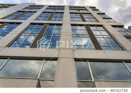 Low angle view of a tall building with reflective glass windows at Salt Lake City in Utah Low angle view of a tall building with reflective glass windows at Salt Lake City in Utah 86582780