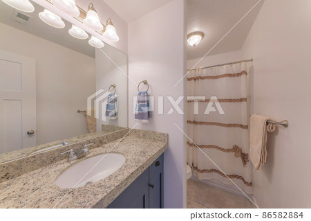 Bathroom interior with vanity sink and lighting fixtures 86582884