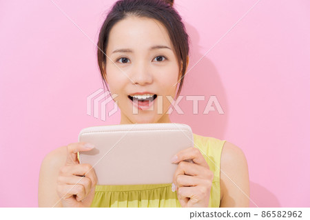 20 多歲粉色背景錢包中的女性 86582962