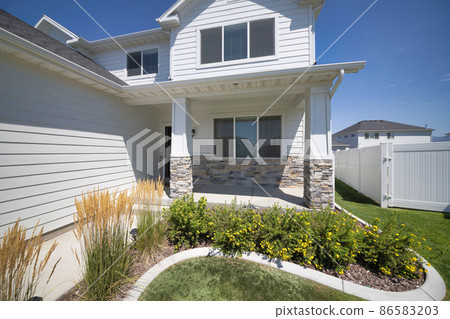 Facade of a house with traditional design and front yard garden at Utah 86583203