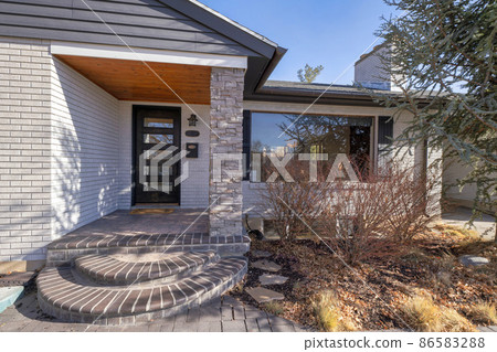 Modern traditional house with white bricks siding and large picture window with fake shutter design 86583288