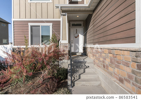 Front exterior of a house with messy front yard garden Front exterior of a house with messy front yard garden 86583541