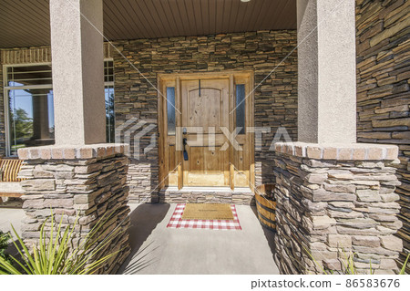Entrance exterior of a house with stone veneer siding 86583676