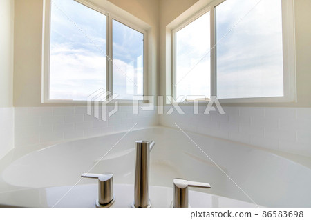 Corner bathtub with deck-mounted widespread faucet in all white Corner bathtub with deck-mounted widespread faucet in all white 86583698