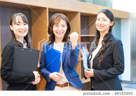 Three women holding a file and doing a guts pose 86583893