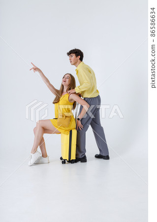 Beautiful young couple travelers having fun in studio 86586634