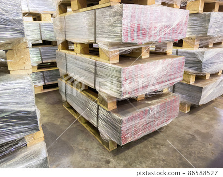 abstract industrial palleted production stacks indoors on the floor 86588527