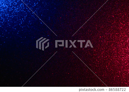 Blur sparks background. Shiny glow. Festive night illumination. Defocused blue red color light sparkling glitter grain texture on dark black abstract overlay. 86588722