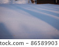 A snowy field shining in the morning sun 86589903