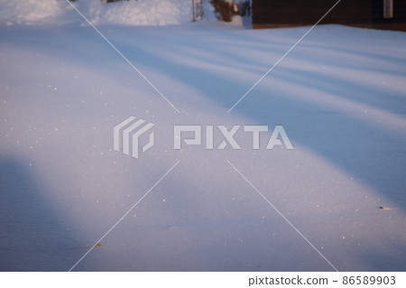 A snowy field shining in the morning sun A snowy field shining in the morning sun 86589903