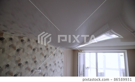 Stretch ceiling in the room filled with water. Flood, water leakage from the ceiling in the apartment. 86589931