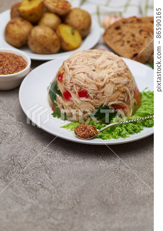 Delicious chicken aspic on a plate on concrete table 86590165