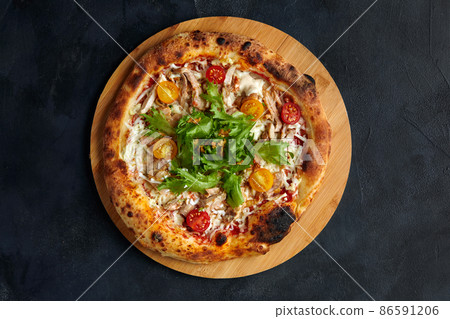 Pizza Caesar. Pizza with chicken, tomato, cheese and lettuce on stone background. Top view. Free space for your text. Delivery food 86591206