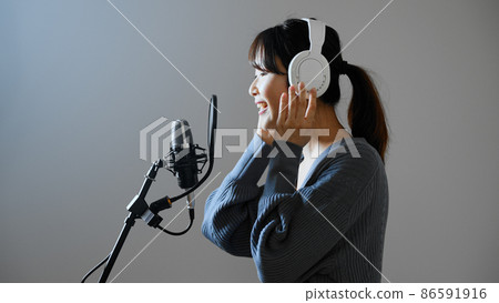 Young woman recording a song 86591916