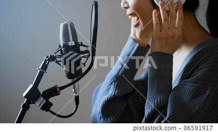 Young woman recording a song 86591917