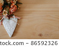 wooden table with an flowers and a heart 86592326