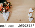 wooden table with an flowers and a heart 86592327