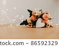 wooden table with a bouquet of flowers and a white heart 86592329