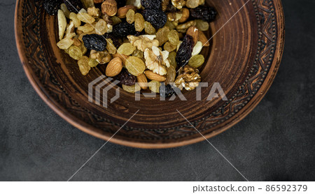 assorted nuts and raisins 86592379