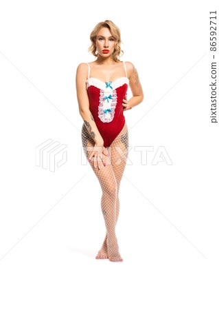 Slim seductive woman in Santa outfit in studio 86592711