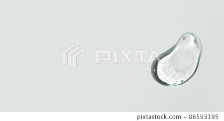 Transparent hyaluronic acid gel drop on a gray background. 86593195