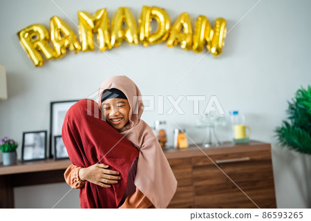 two little young girl with headscarf embracing each other 86593265