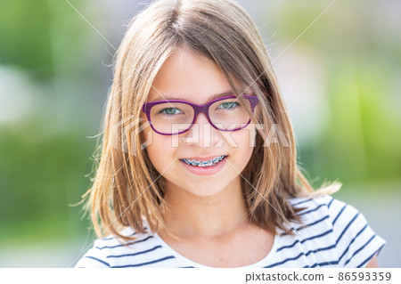 Sovereign look of a young teenage girl with a dental braces and glasses 86593359