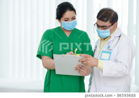 Medical Workers Discussing Document Medical Workers Discussing Document 86593688