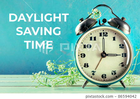 Daylight Saving Time concept, spring forward. A vintage alarm clock 86594042