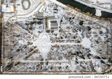 Small park with bare trees covered with snow. Aerial view to winter park in Yekaterinburg Small park with bare trees covered with snow. Aerial view to winter park in Yekaterinburg 86594751