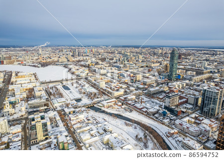 Yekaterinburg aerial panoramic view at Winter in cloudy day. Ekaterinburg is the fourth largest city in Russia located in the Eurasian continent on the border of Europe and Asia. Yekaterinburg aerial panoramic view at Winter in cloudy day. Ekaterinburg is the fourth largest city in Russia located in the Eurasian continent on the border of Europe and Asia. 86594752