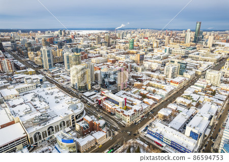 Yekaterinburg aerial panoramic view at Winter in cloudy day. Ekaterinburg is the fourth largest city in Russia located in the Eurasian continent on the border of Europe and Asia. Yekaterinburg aerial panoramic view at Winter in cloudy day. Ekaterinburg is the fourth largest city in Russia located in the Eurasian continent on the border of Europe and Asia. 86594753